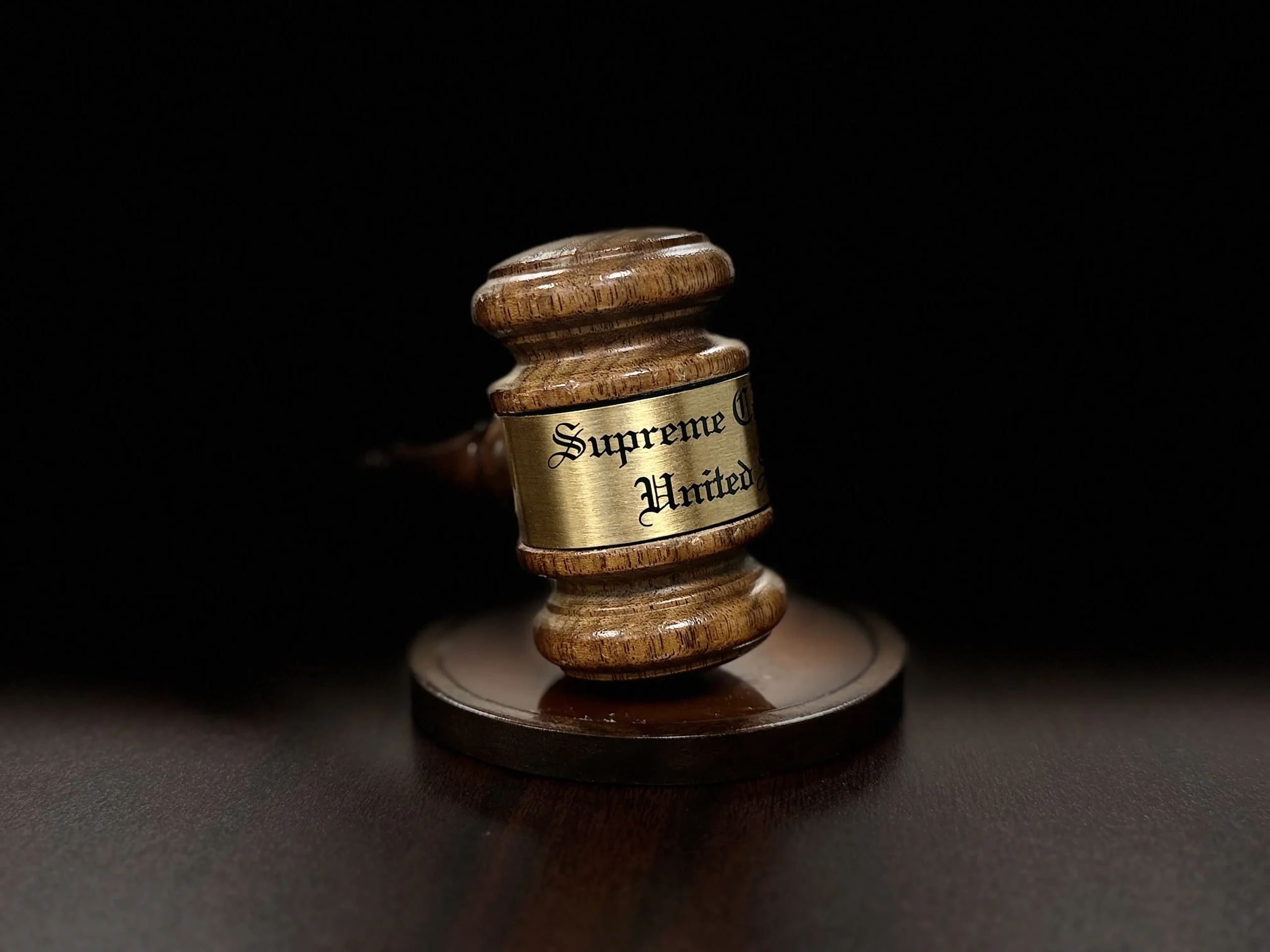 Formal courtroom setting with dark wood paneling representing trial defense